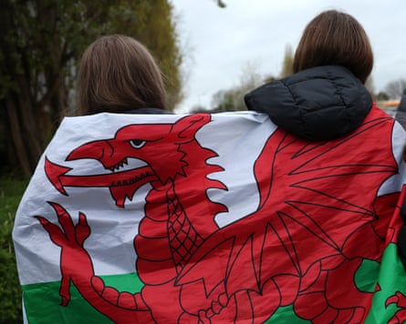 Back position of 2 young group wrapped successful Welsh flag