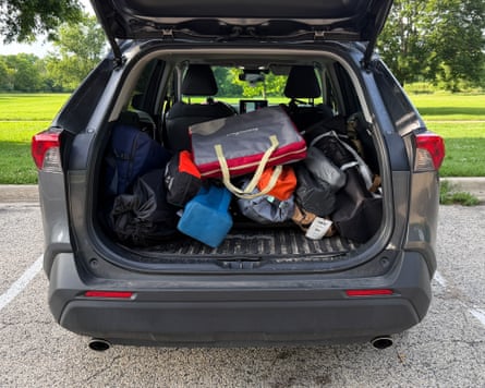 A collection of camping chairs photographed in the back of a car