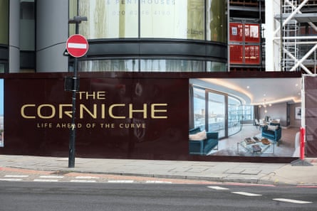 Billboards outside the new development in March 2017. There is a large CGI image showing the interior of a luxury flat and the words: The Corniche. Life Ahead of the Curve.