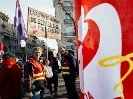 A protester holds a placard reading ‘retirement at 60 through a pay-as-you-go system and that’s that’ at a demonstration in Paris
