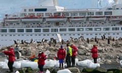 Ships carrying less than 500 passengers are permitted to make landings in Antarctica. The green vest identifies a staff member who plays an important role in interpretation as well as crowd control and environmental protection. The telephoto lens makes this ship look like it’s parked on the beach when in fact it is a safe distance offshore.