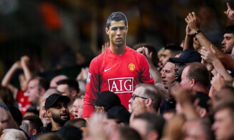 A cardboard cutout of Cristiano Ronaldo is passed around the Manchester United fans at Wolves. He is poised to make his second United debut against Newcastle.