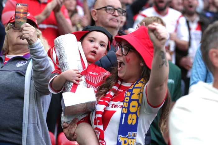 St Helens fans, complete with a tinfoil cup, cheer their side ahead of kick-off.