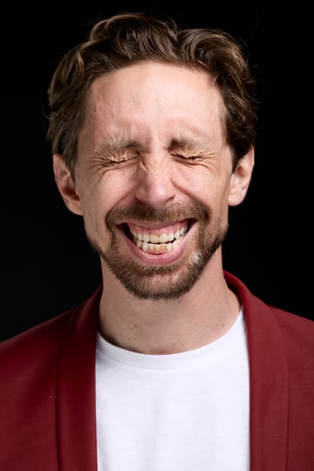 Closeup of Eric Lampaert with a wide grin and his eyes screwed up