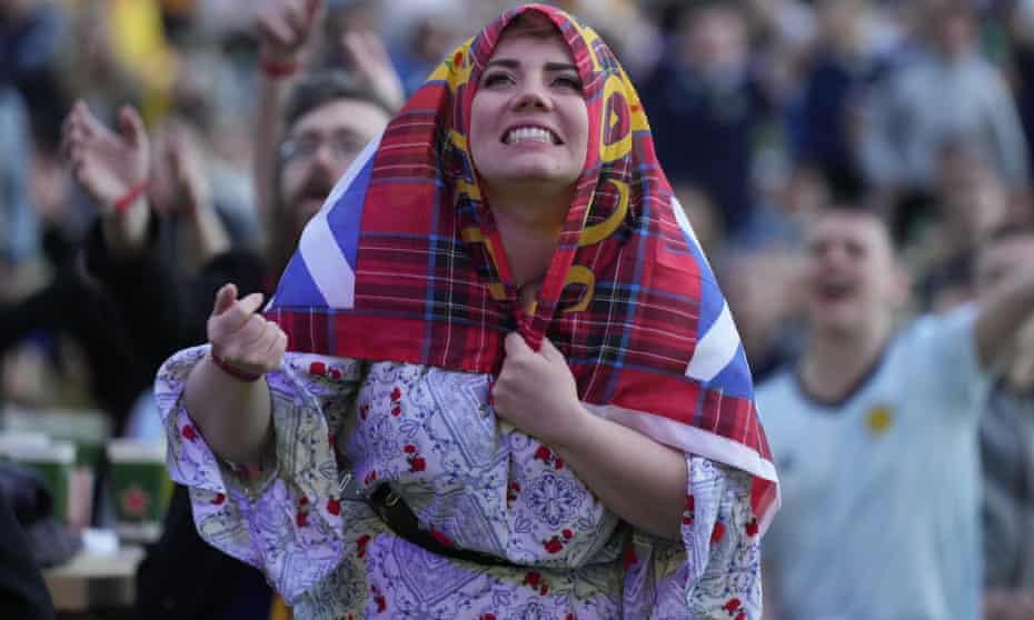 A Scotland fan watches the 0-0 draw with England at the fan zone in Glasgow.