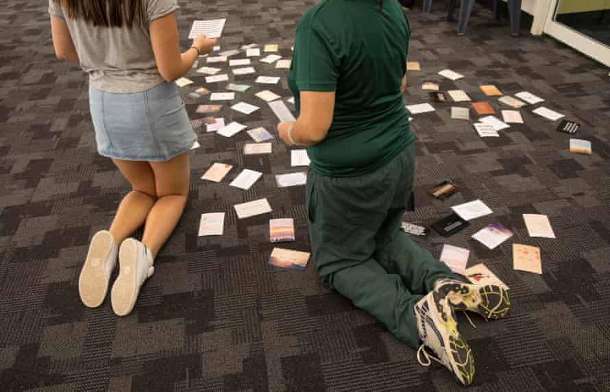 Cards with positive messages have been placed on the floor in a heart shape by Shine For Kids staff.