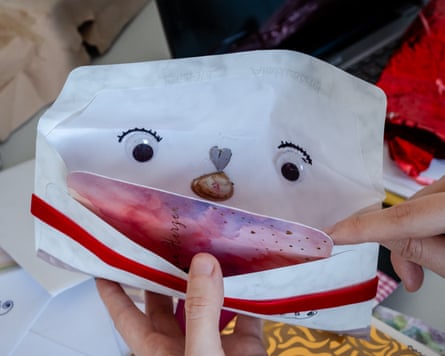 An envelope with googly eyes and a face drawn on the inside