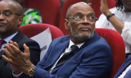 Ariel Henry attends a public lecture at the United States International University in Nairobi, Kenya, 1 March 2024: he is seated in a hall and clapping