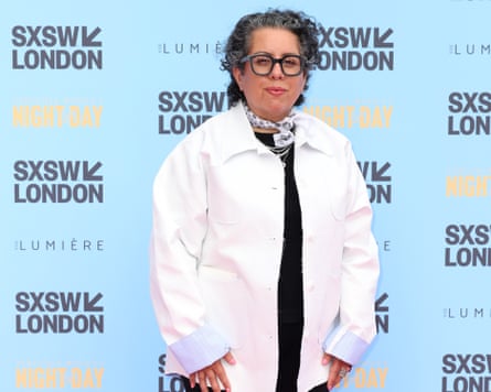 Tina Gharavi on the red carpet wearing a bright white jacket