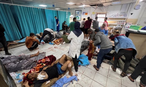 Palestinians wounded in Israeli strikes lie on the floor of the Indonesian hospital on 16 November.