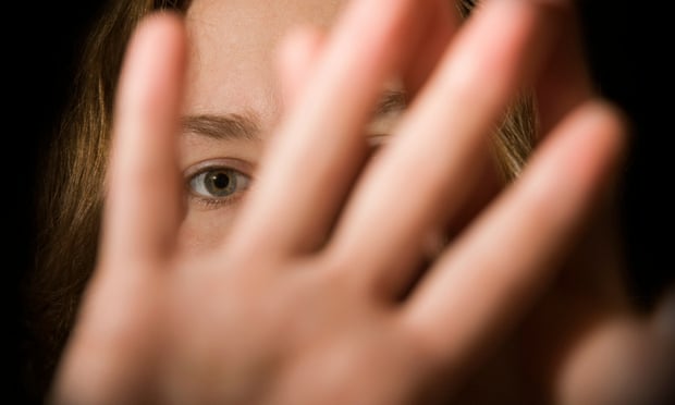 A woman’s hands in front of her face.