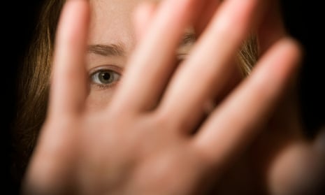 A woman’s hands in front of her face.