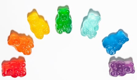 Colourful gummy bears in arranged into a half circle, on a white background