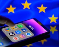 Google, Facebook, LinkedIn, Amazon, Apple Store, and TikTok apps on a smartphone with the EU flag