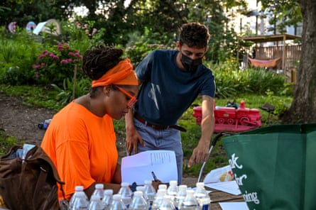 Melissa Barber, a researcher and co-founder of South Bronx Unite, works with a volunteer on the heat mapping project in the Mott Haven neighborhood of Bronx, New York.
