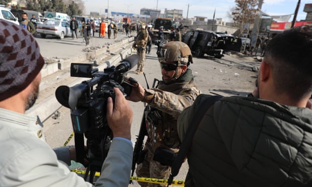 Afghan security police block a TV journalist from filming at the site of bombing attack in Kabul in February. The city fell to the Taliban on Sunday.