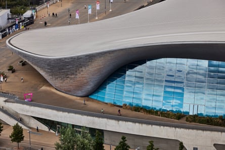 Overhead view of London Aquatics Centre with its sweeping roof and blue glass windows. 