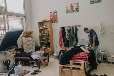 Makeshift dormitory accommodation with some of its male occupants