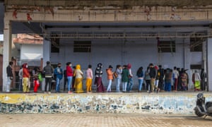 Covid live news: France to ease some restrictions; tsunami-hit Tonga enters lockdown | World news 2 A group of people wait to get vaccinated outside the government Covid vaccination centre in Ghaziabad.