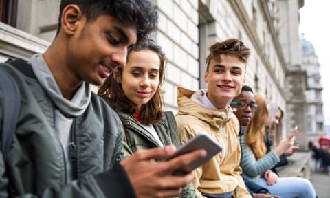 Teenagers students using smartphone on a school break
