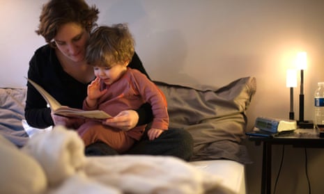 A woman reads a story to her child. A recent survey found that a third of parents never read a bedtime story to their children. 