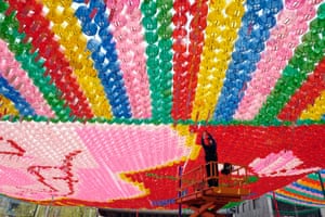 Seoul, South Korea: A South Korean Buddhist arranges decorative lotus lanterns at a temple in preparation for the Buddha’s birthday
