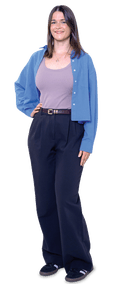 Louise, in a blue cardigan, lilac top and dark trousers, smiles with hand on hip