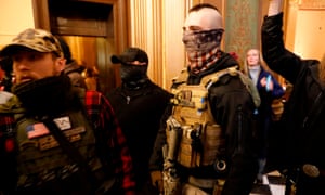 Protesters try to enter the Michigan house chamber in the state capitol building in Lansing, Michigan, on 30 April.