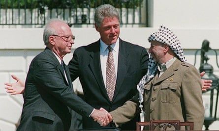 Clinton with Yasser Arafat (right) in his historic handshake with with Yitzhak Rabin on the White House lawn, September 1993.