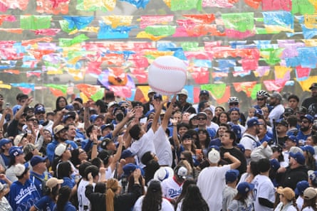 Fans reach for an inflatable baseball during the parade.