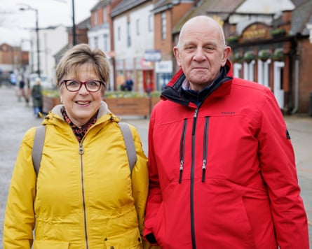 Sue Cox in a bright yellow coat and Mick Cox in bright red