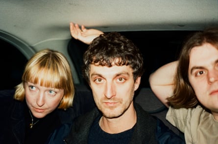 Three musicians in the back of a taxi
