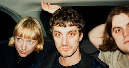 The three members of Tara Clerkin Trio in the back of a car.