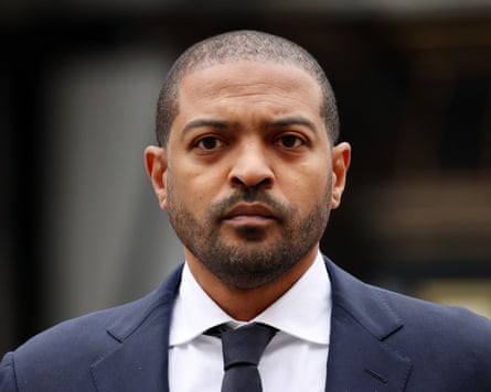 Noel Clarke in a suit outside court