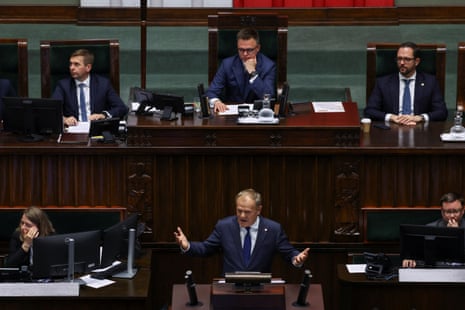 The speaker of the Polish Parliament, Szymon Hołownia, observes as prime minister Donald Tusk responds to parliamentary inquiries on the day a vote of confidence is scheduled for his coalition government in Warsaw, Poland.
