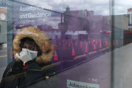 A woman waits for a bus near a coronavirus testing site in Brooklyn.