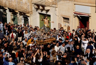 A statue of Jesus is carried at a procession in Malta