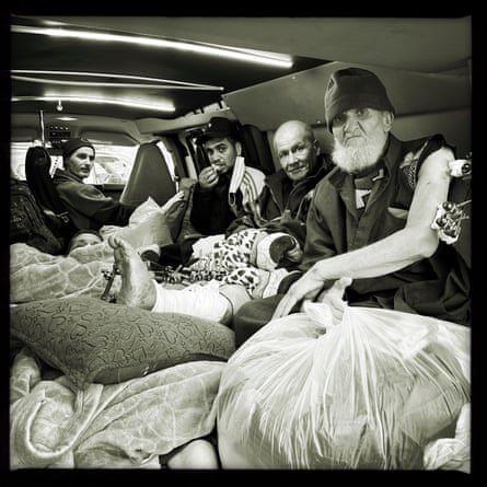 People crowded into the back of an ambulance