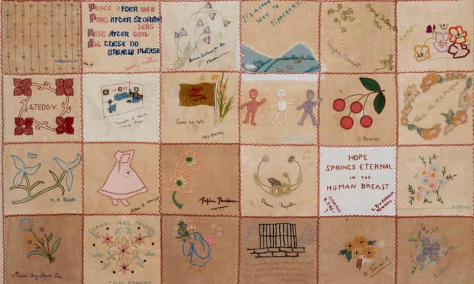 A close up of rtows of neat embroidered square of a quilt with a wide variety