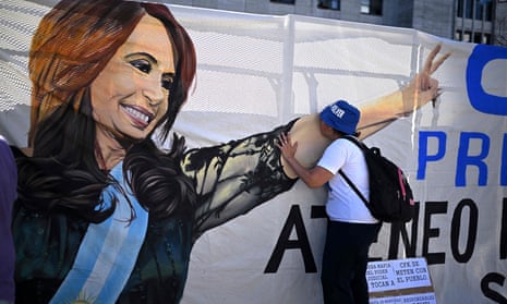 A supporter of Argentina's Vice-President Cristina Fernández de Kirchner kisses her image in a huge banner hung outside a courthouse in Buenos Aires.