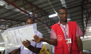 Electoral workers sort ballots at a tabulation center in Port-au-Prince, Haiti, on Monday.