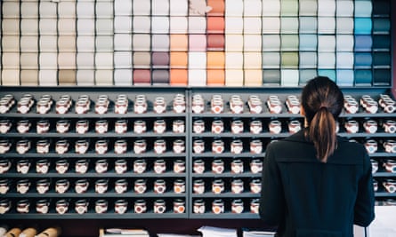 Rear view of woman choosing wallpapers and paints