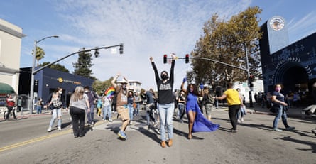 People celebrate in the street in Oakland.