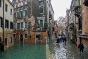 Venetians make their way through flooded streets