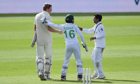 After being dismissed for 267, Zak Crawley of England (left) is congratulated by Mohammad Rizwan (centre) and Asad Shafiq.