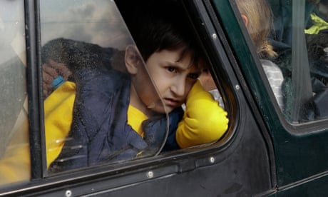 A refugee boy from Nagorno-Karabakh region looks out of a car window.