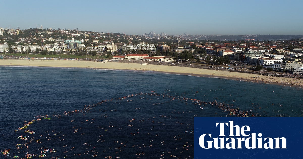 Bondi paddle-out: surfers, paddleboarders and swimmers pay tribute to victims of mass shooting