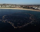 Bondi paddle-out: surfers, paddleboarders and swimmers pay tribute to victims of mass shooting