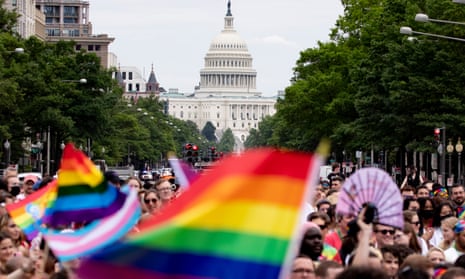 The US Capitol seen behind Pride flags as people participate in the Pride parade in Washington DC, on 12 June 2021.