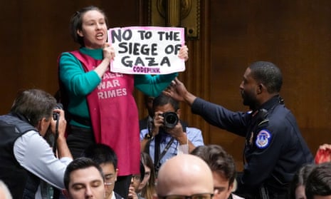 A US Capitol police officer moves to detain a protester with Code Pink during a US Senate appropriations hearing today on aid to Israel and Ukraine.